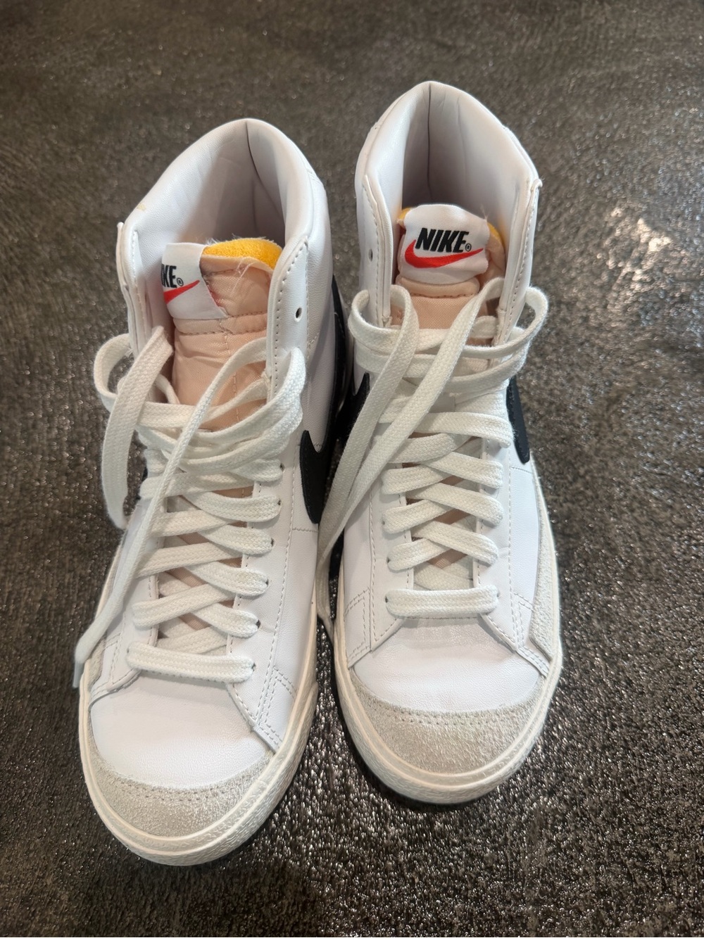 Nike White High-Top Sneakers with Black Swoosh and Yellow Tongue Accent